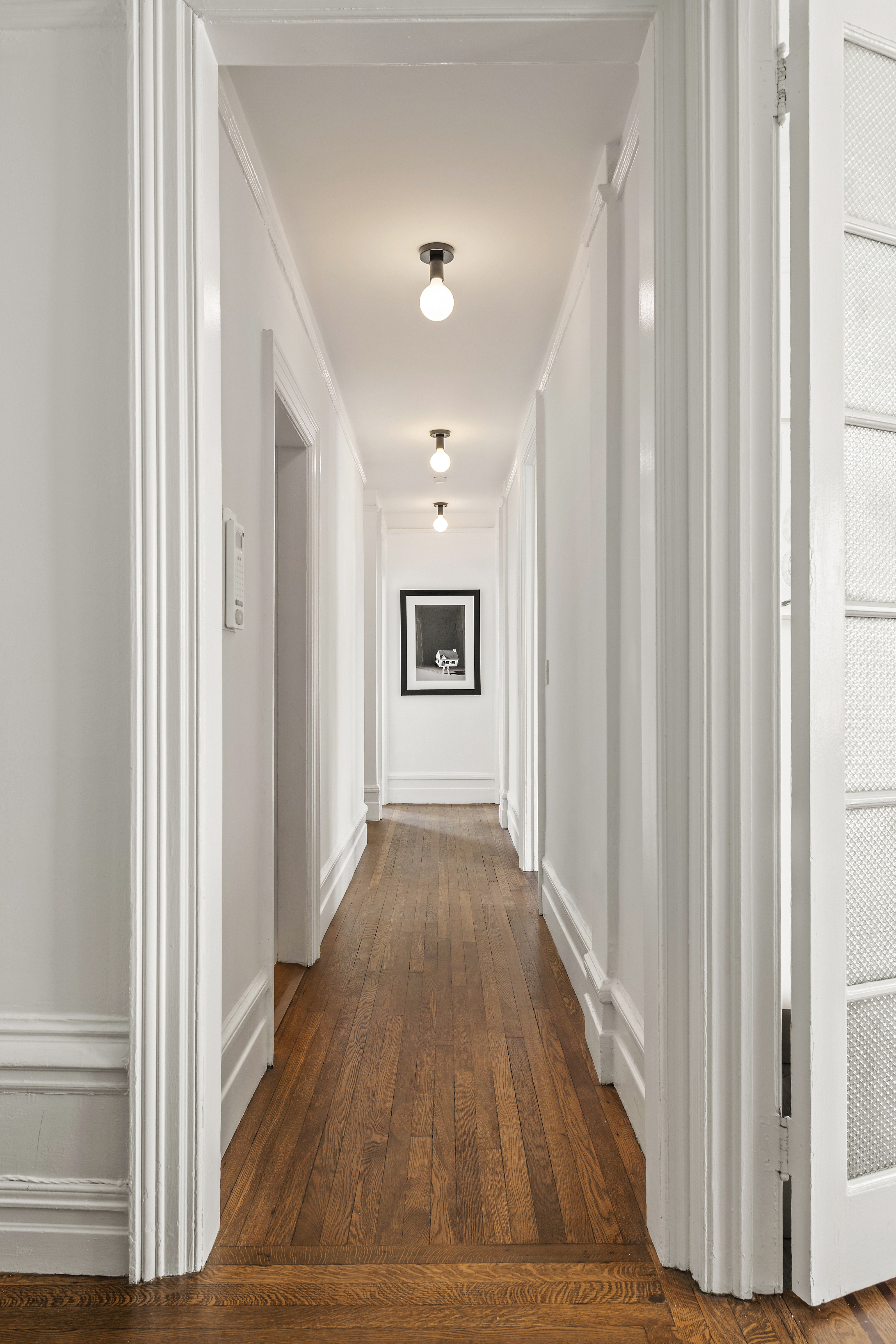 600 West 115th Street, Unit 1004 Manhattan, NY 10025 - Photo 4 of 13 a view of a hallway with wooden floor and staircase