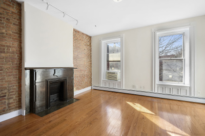 67 Gates Avenue, Unit 2 Brooklyn, NY 11238 - Photo 2 of 4 a view of an empty room with a fireplace and a window