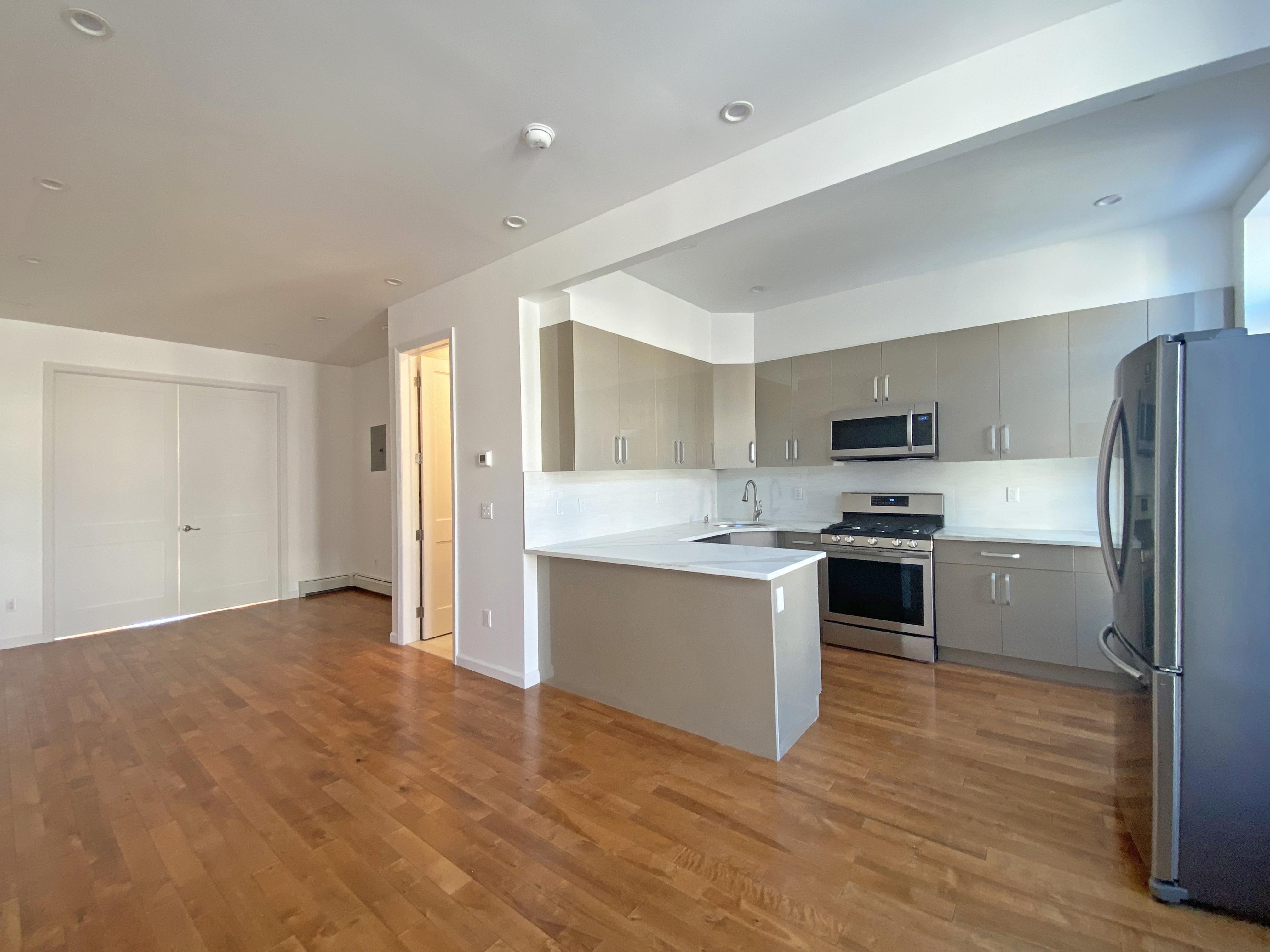 175 Luquer Street, Unit 3 Brooklyn, NY 11231 - Photo 4 of 12 a kitchen with a refrigerator and a stove top oven