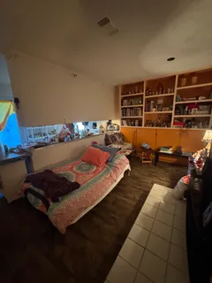 a bed room with a bed and a book shelf