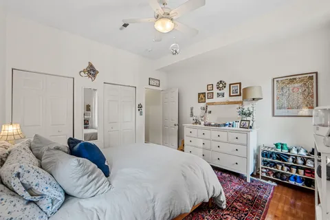 a kitchen with a stove a sink cabinets and wooden floor