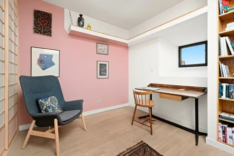 a view of a workspace with furniture and a potted plant