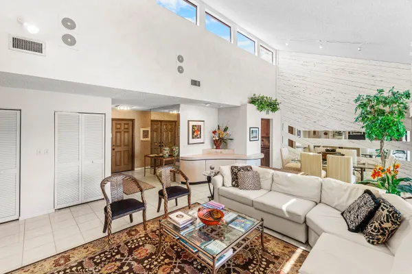 a living room with furniture a rug and a table