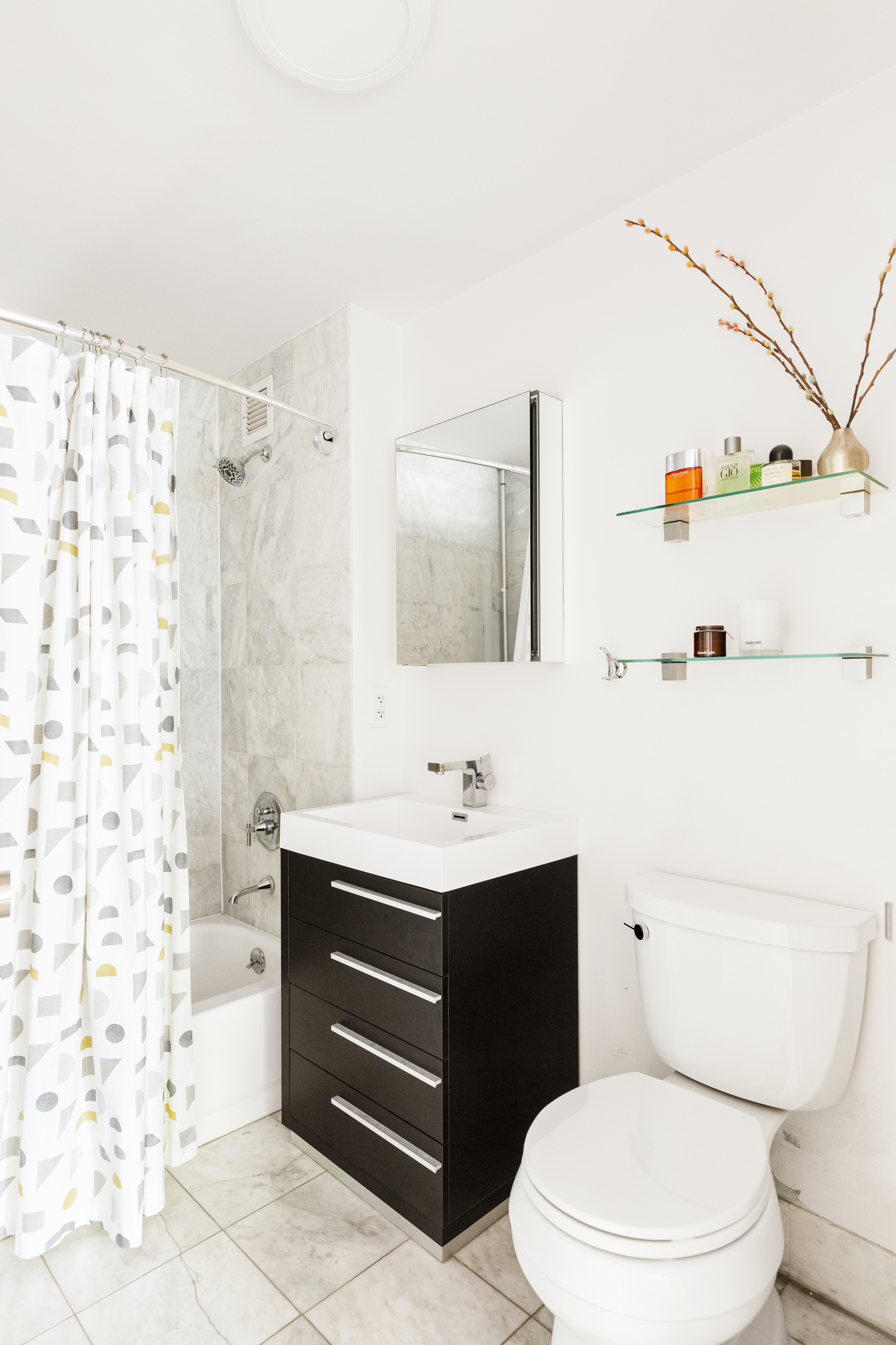 736 West 187th Street, Unit 303 Manhattan, NY 10033 - Photo 8 of 16 a bathroom with a sink a toilet and shower curtain