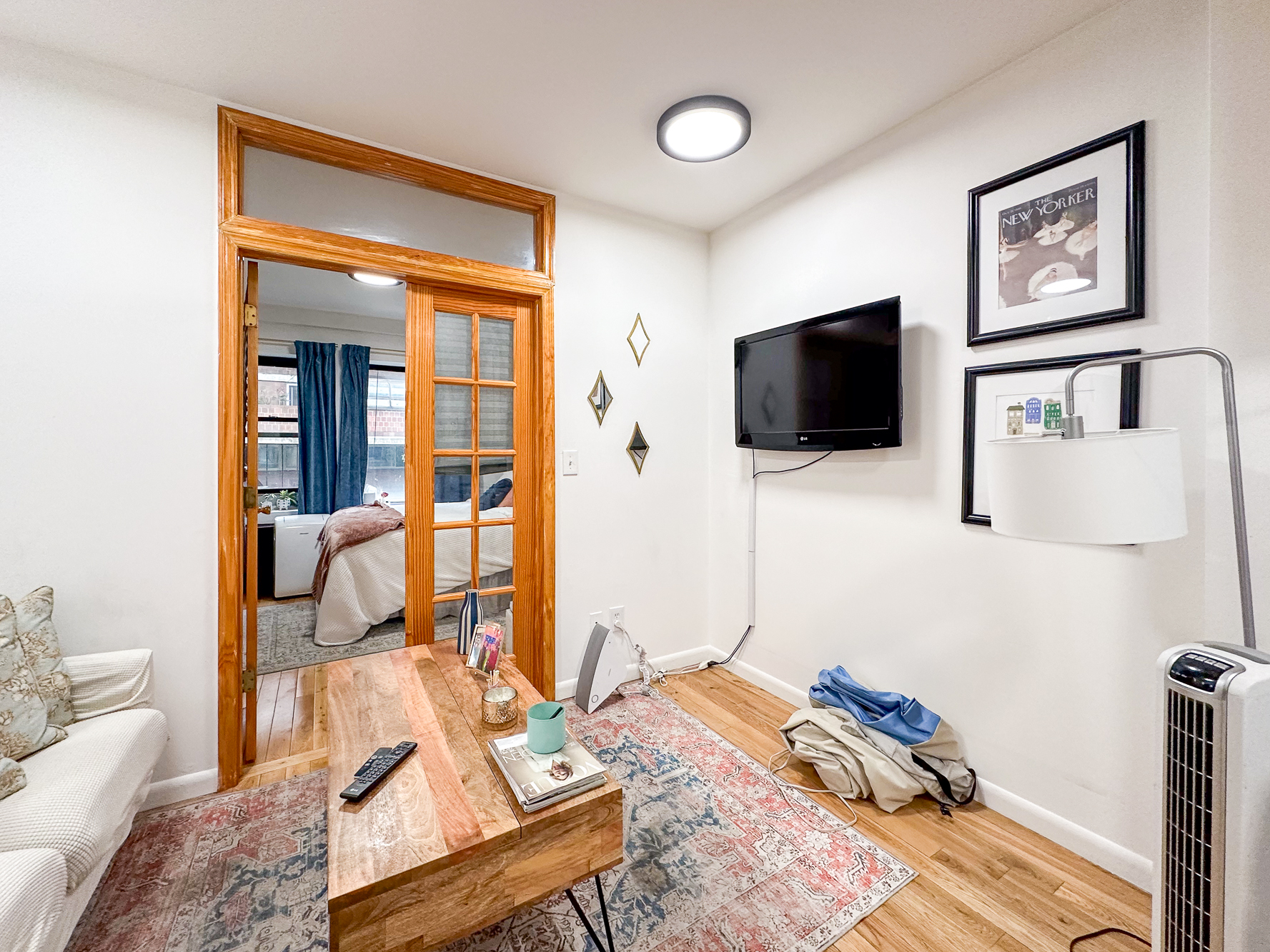 321 East 25th Street, Unit 3A Manhattan, NY 10010 - Photo 3 of 15 a living room with furniture and a flat screen tv