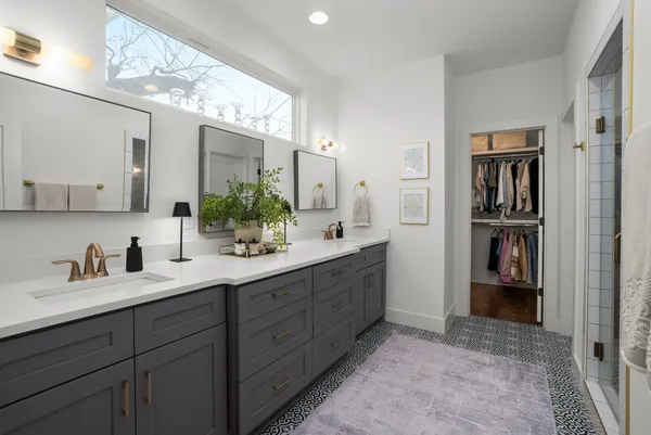 a bathroom with a double vanity sink and a mirror