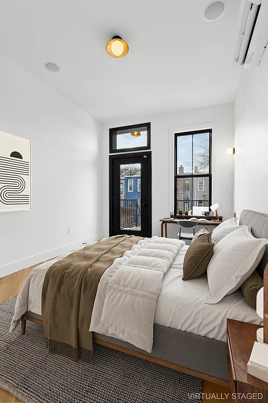 1265 Madison Street, Unit 2 Brooklyn, NY 11221 - Photo 4 of 9 a bedroom with a bed and a large window