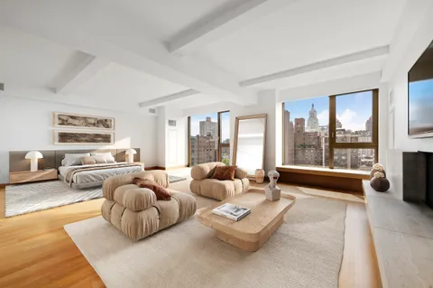 a living room with furniture and a large window with balcony view