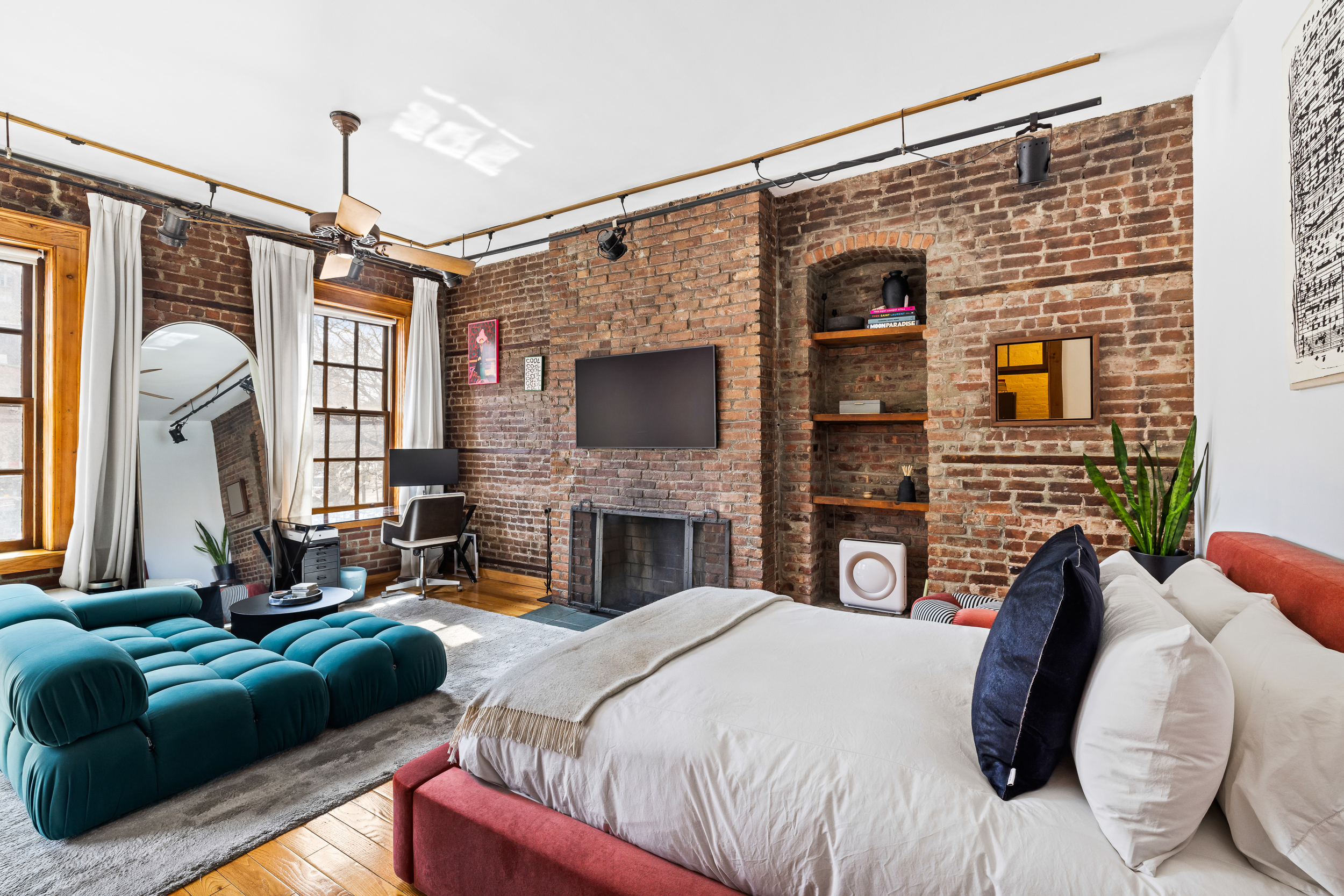 31 8th Avenue, Unit 1 Manhattan, NY 10014 - Photo 2 of 10 a bedroom with a bed window and a fireplace