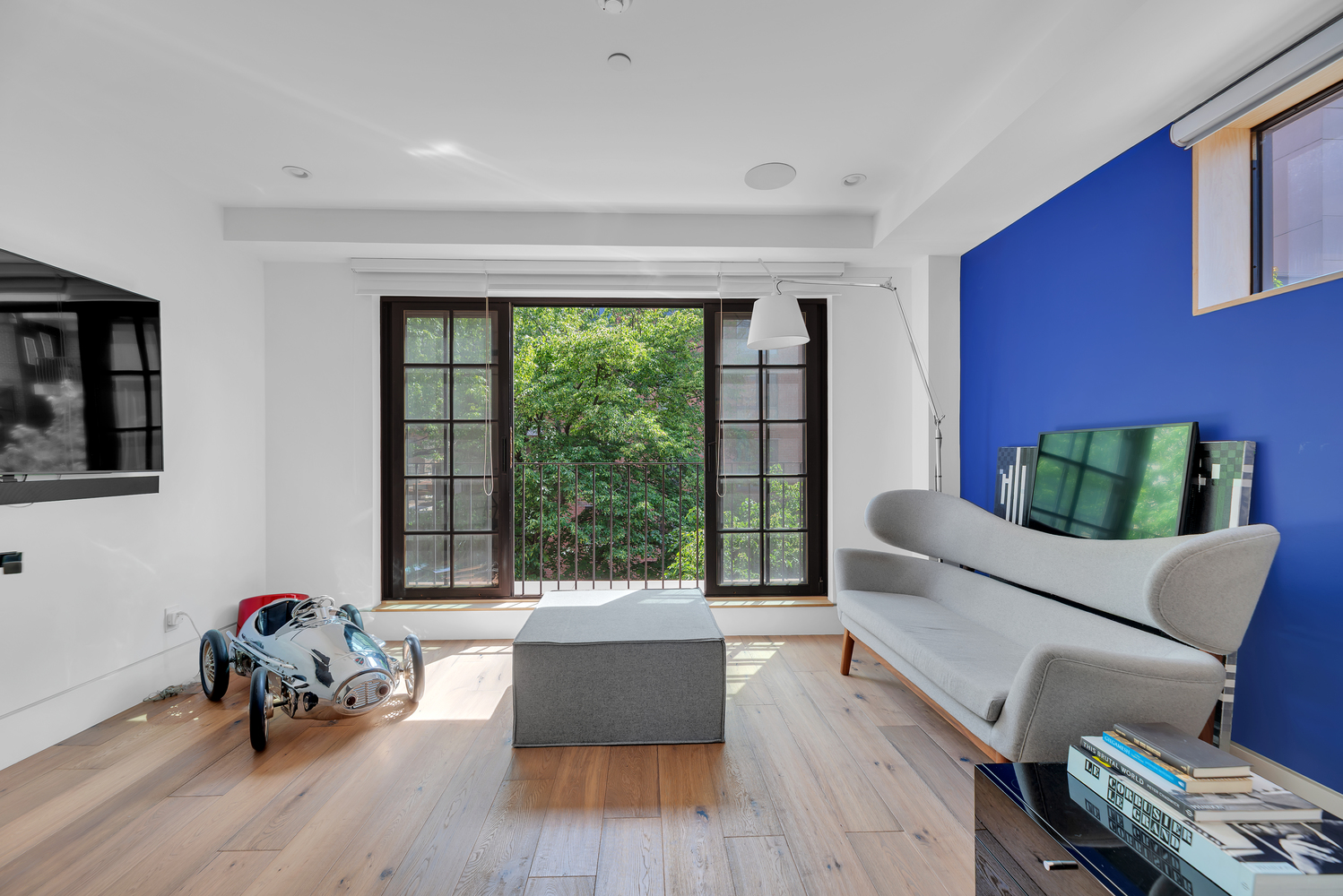 440 West 20th Street Manhattan, NY 10011 - Photo 13 of 35 a living room with furniture and a large window