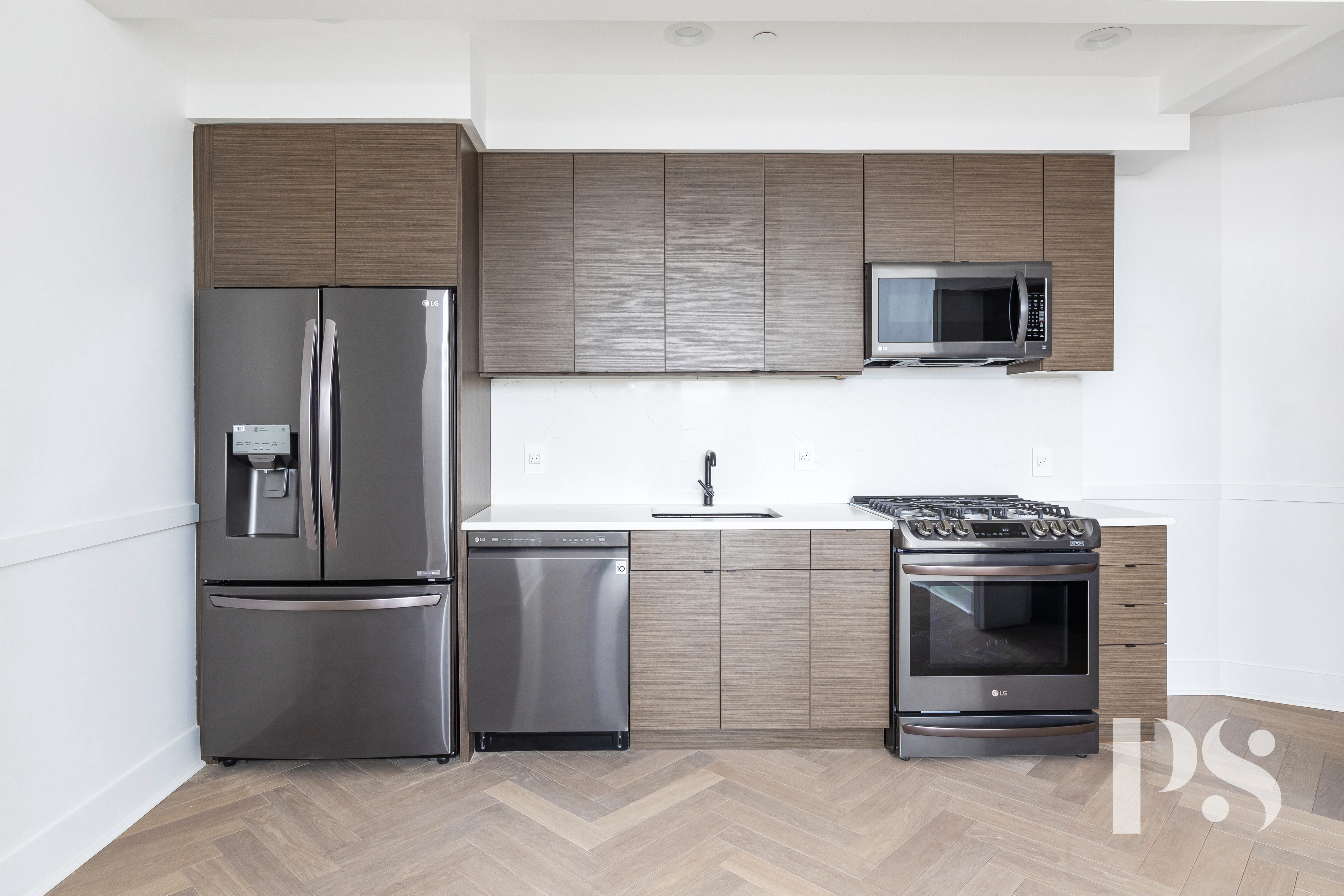 47-16 Greenpoint Avenue, Unit 4B Queens, NY 11104 - Photo 3 of 9 a kitchen with a sink stainless steel appliances and cabinets
