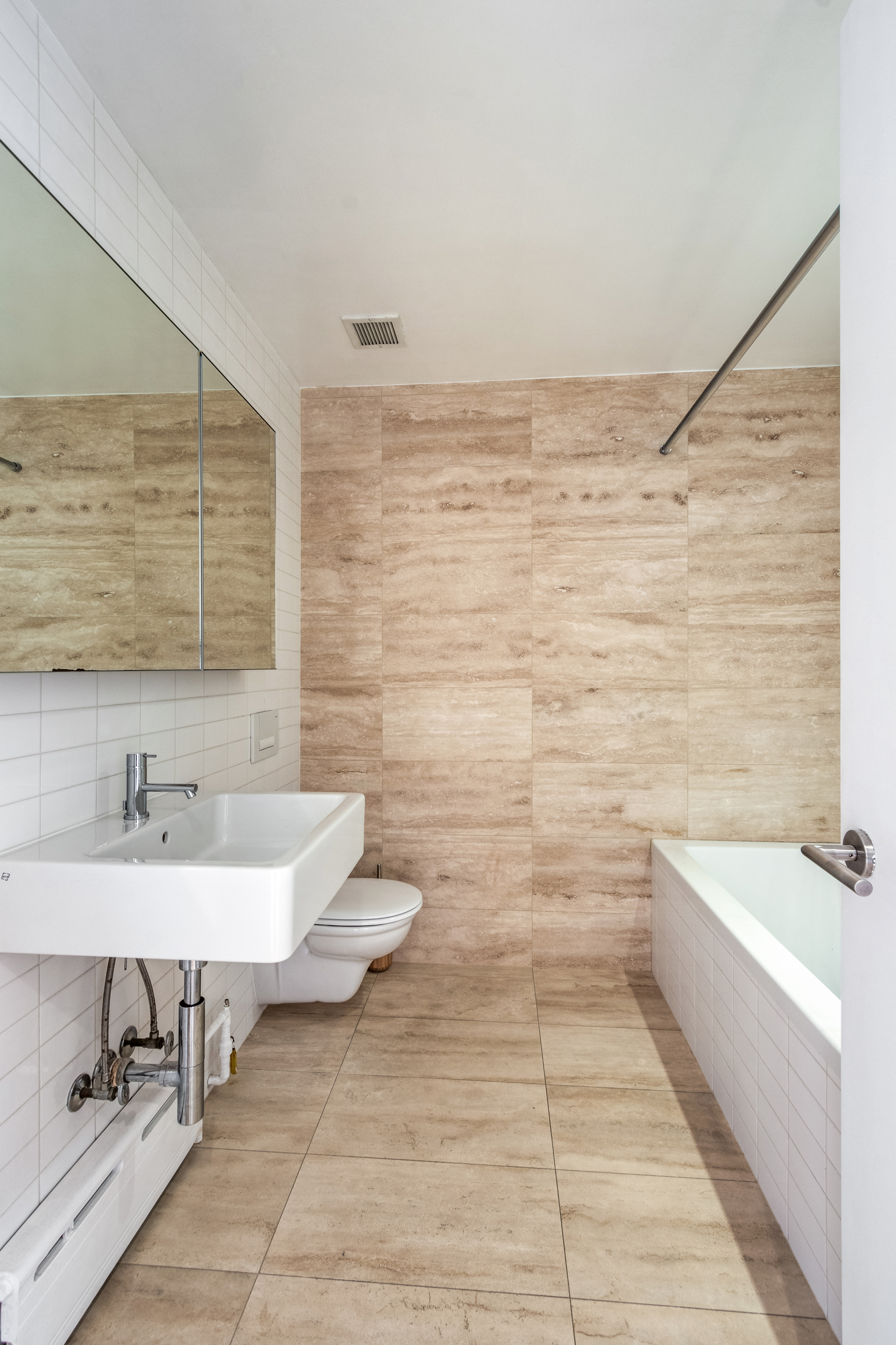 109 Norfolk Street, Unit 5 Manhattan, NY 10002 - Photo 10 of 14 a bathroom with a sink a toilet and bathtub