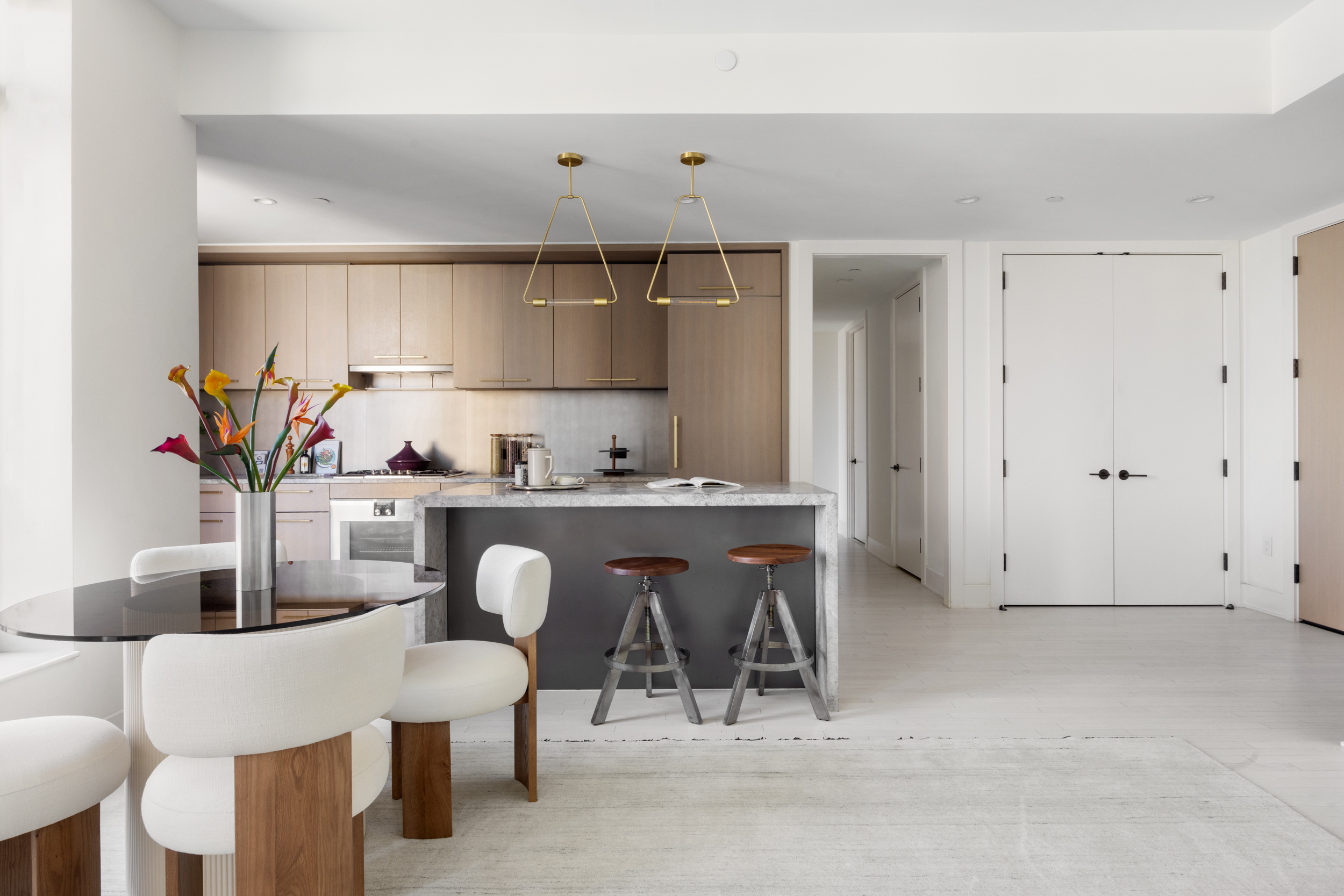 91 Leonard Street, Unit 11G Manhattan, NY 10013 - Photo 4 of 16 a dining room with furniture a potted plant and a kitchen view