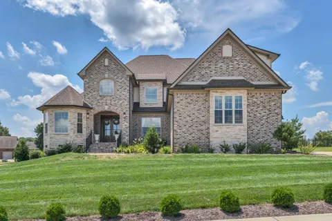 a front view of a house with a garden