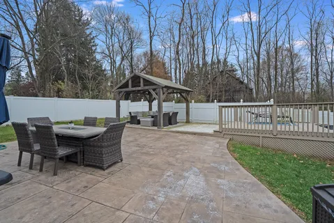 a view of a house with backyard and sitting area