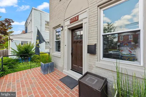 a view of front door of house with a patio