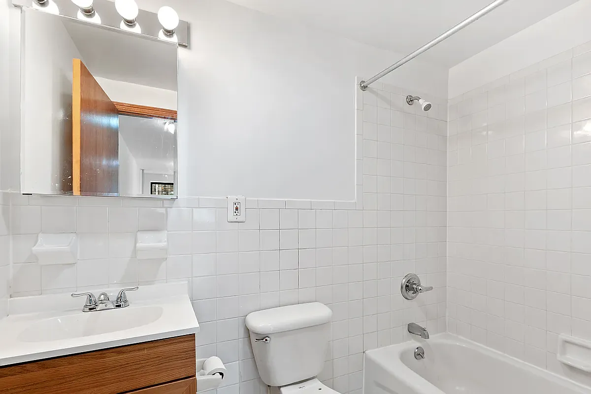 107 East 2nd Street, Unit 11 Manhattan, NY 10009 - Photo 4 of 7 a bathroom with a sink toilet and shower