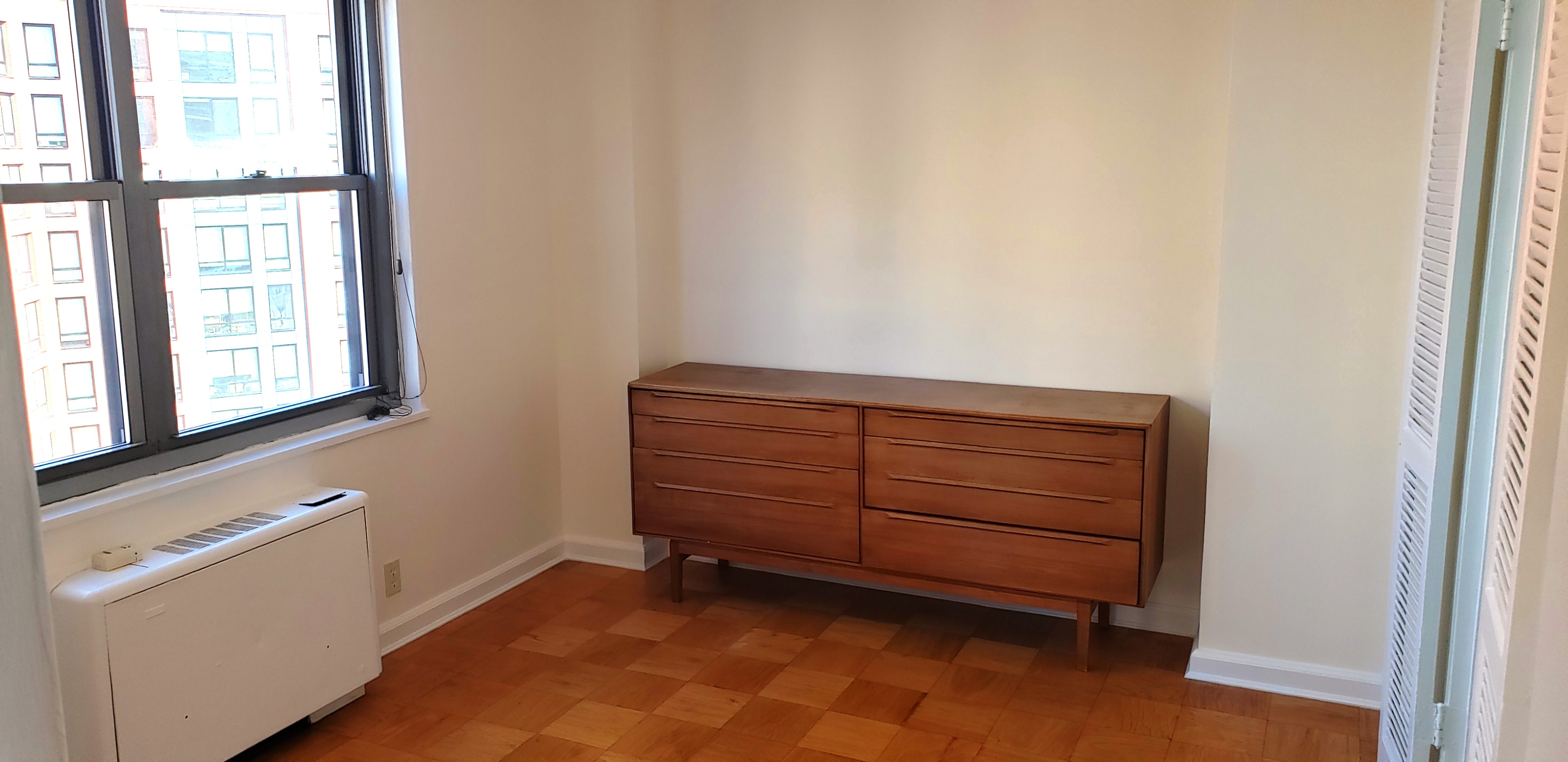 70-25 Yellowstone Boulevard, Unit 11D Queens, NY 11375 - Photo 11 of 25 a view of an empty room with a window