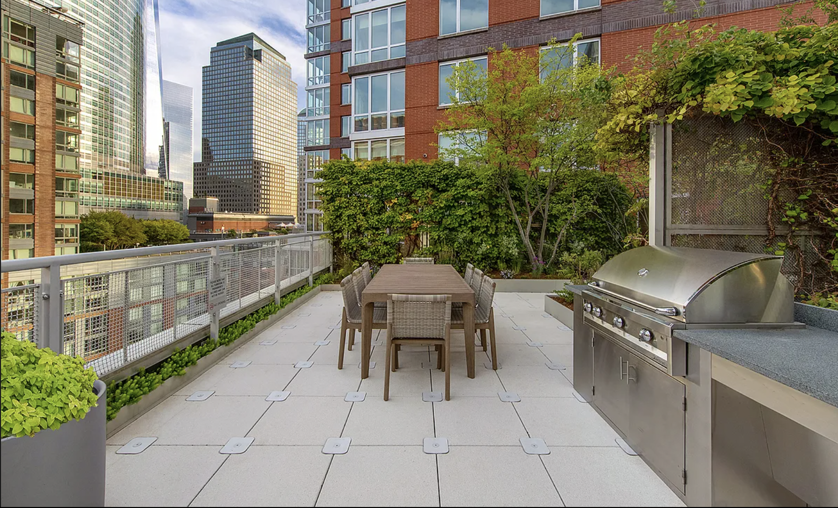 20 River Terrace, Unit 6Q Manhattan, NY 10282 - Photo 10 of 20 a view of a chairs and table in the balcony