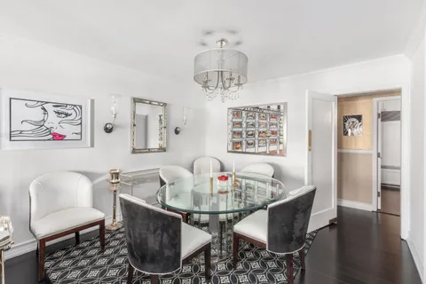 a dining room with furniture a window and wooden floor