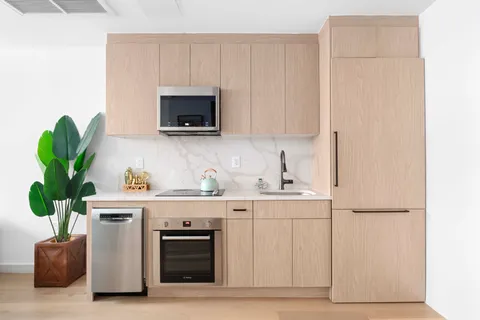 a kitchen with a microwave a stove and cabinets