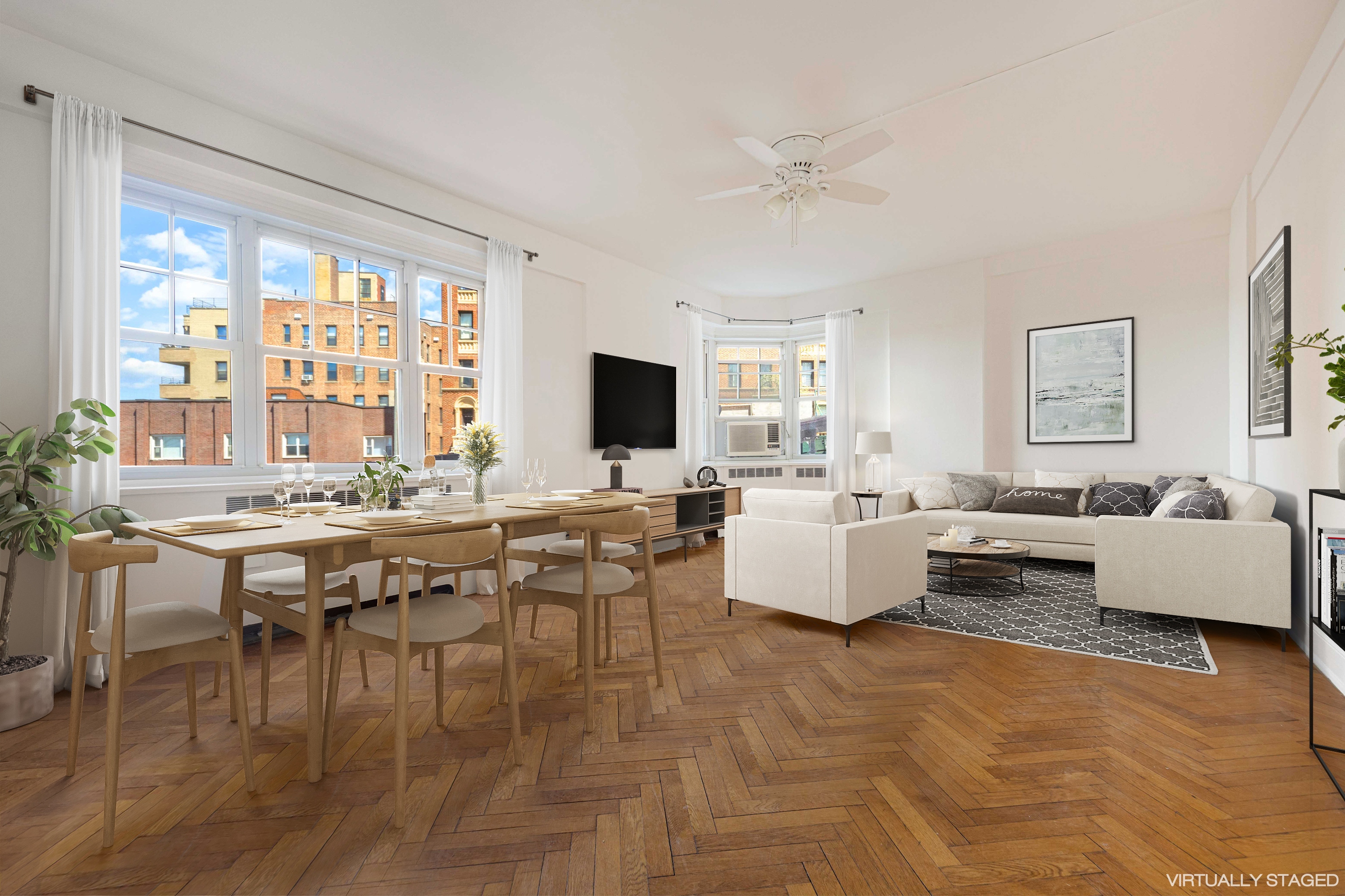 200 Cabrini Boulevard, Unit 17 Manhattan, NY 10033 - Photo 1 of 24 a living room with couches and a flat screen tv with kitchen view