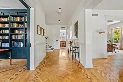 a living room with furniture a rug and a fireplace