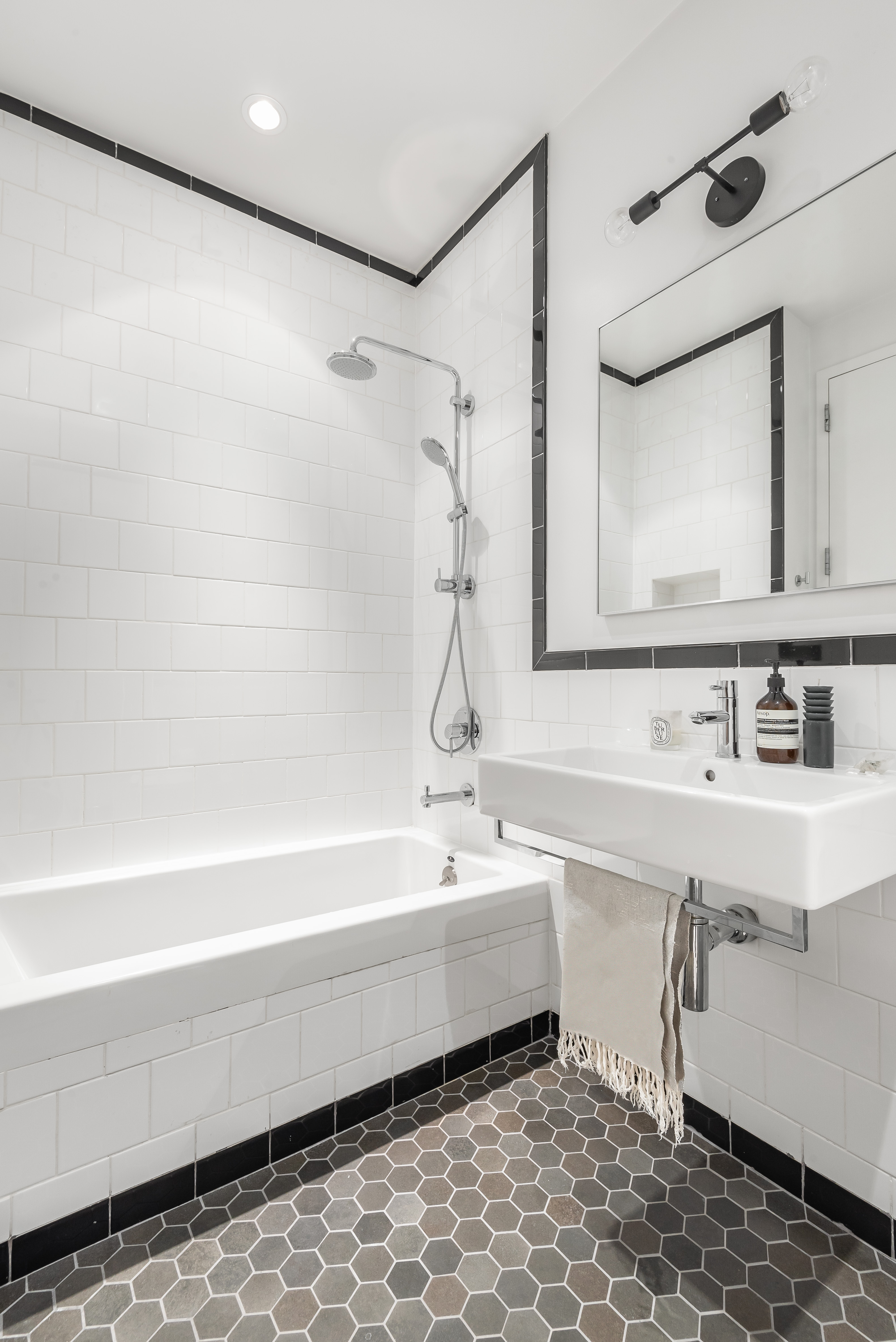 55 Berry Street, Unit 2B Brooklyn, NY 11249 - Photo 7 of 12 a bathroom with a sink a mirror and a bathtub