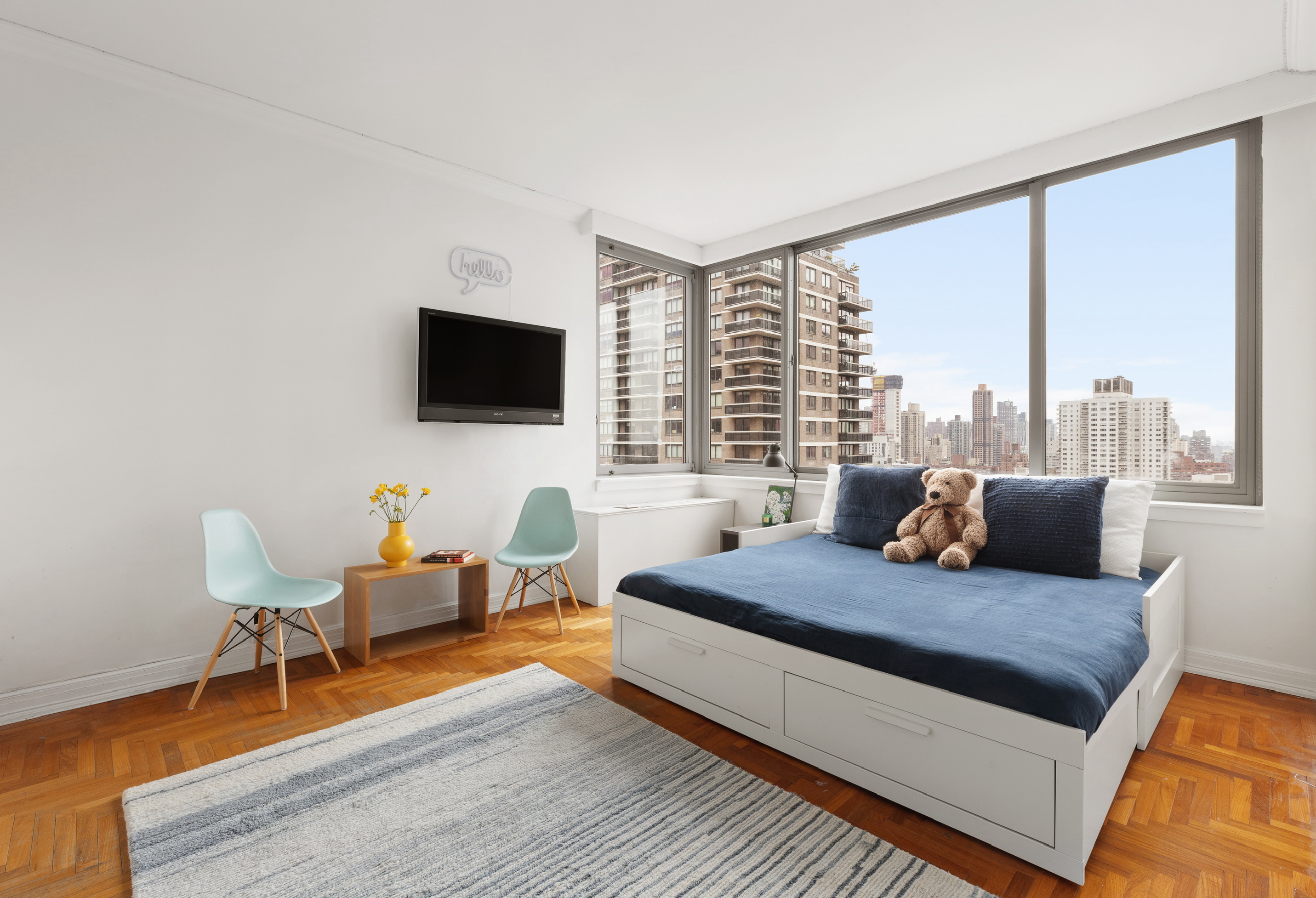524 East 72nd Street, Unit 28DE Manhattan, NY 10021 - Photo 5 of 14 a living room with furniture and a flat screen tv
