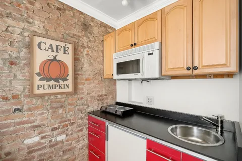 a kitchen with stainless steel appliances granite countertop a sink and a microwave