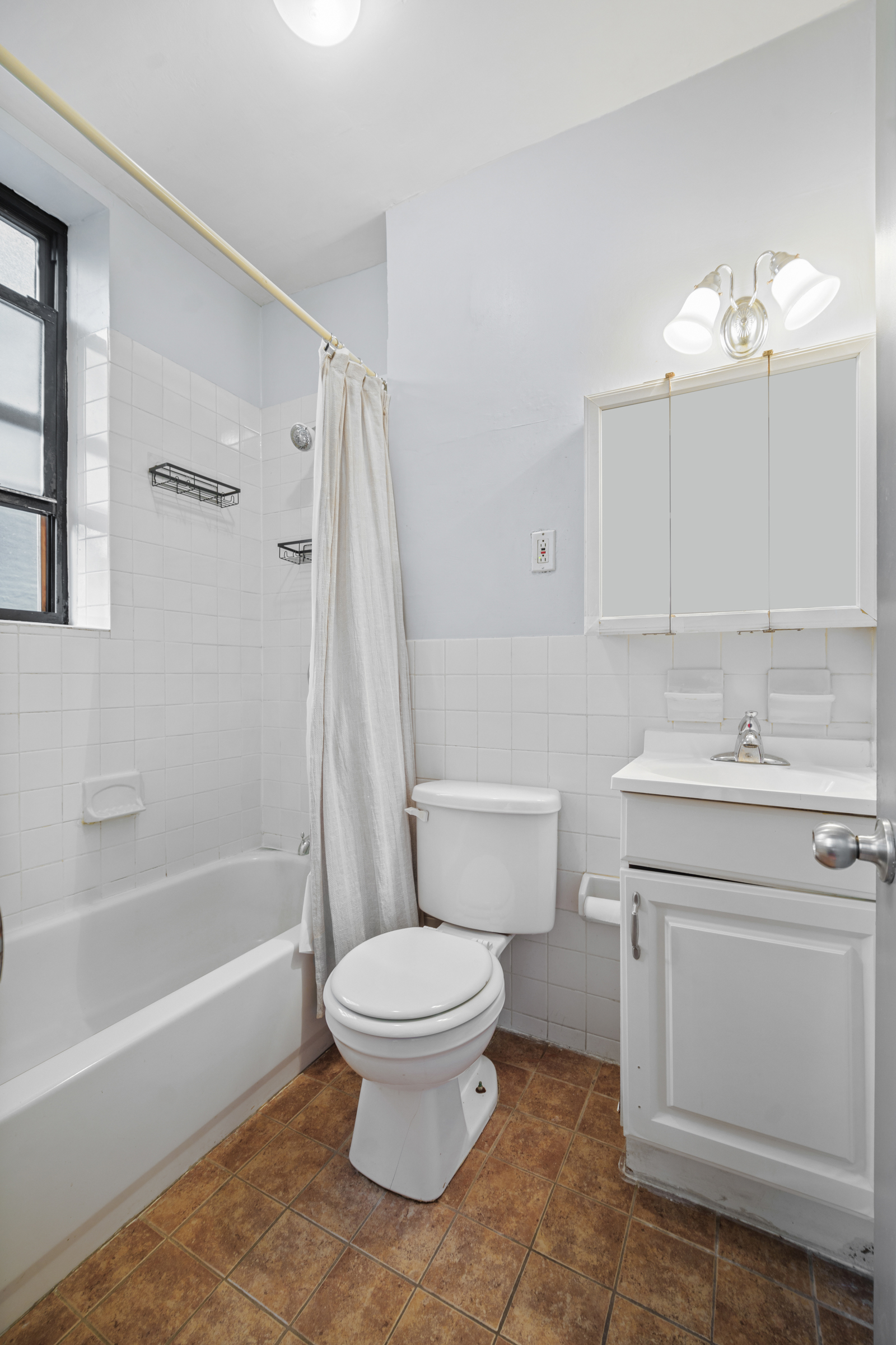 1663 1st Avenue, Unit 2S Manhattan, NY 10028 - Photo 6 of 6 a bathroom with a sink toilet and shower