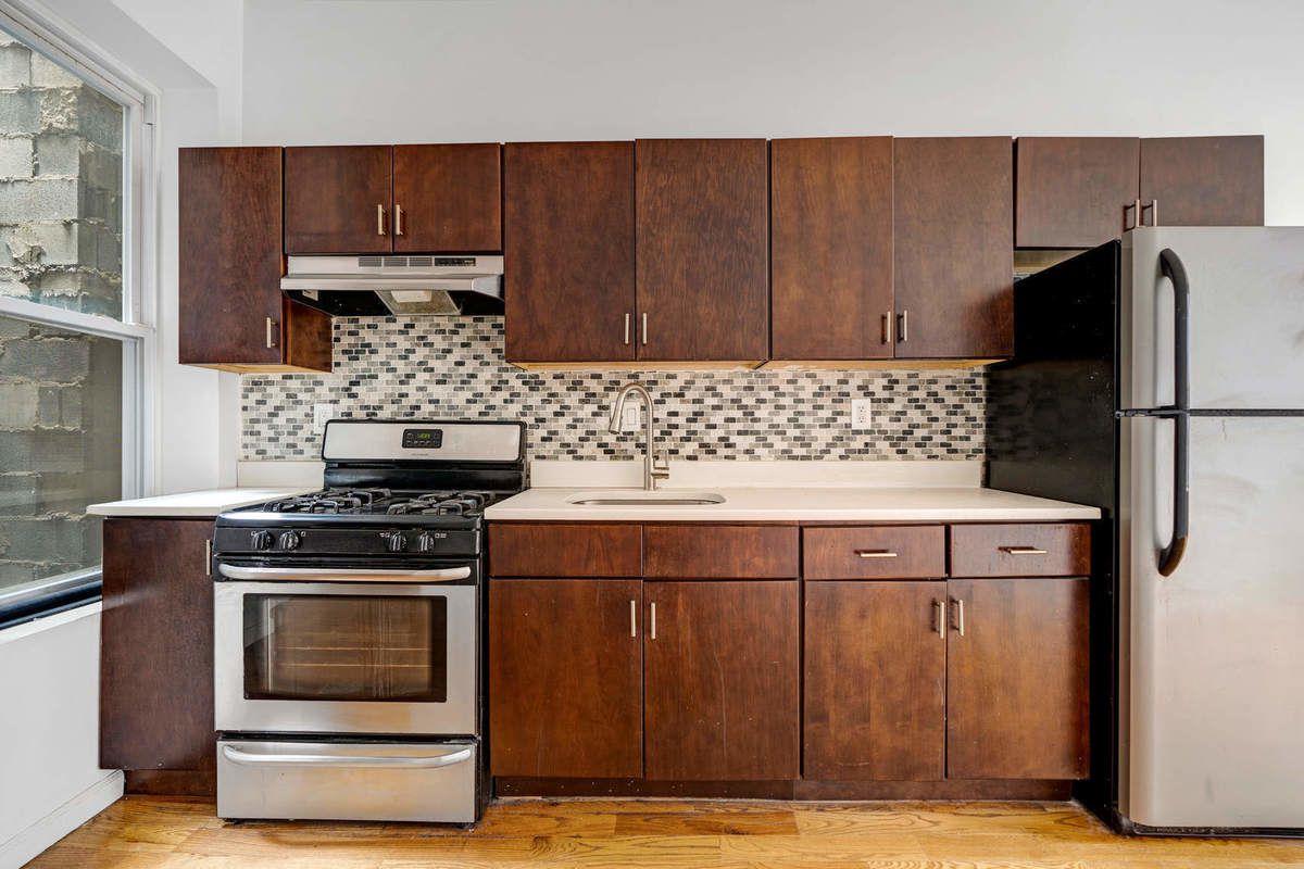 1235 Decatur Street, Unit 2 Brooklyn, NY 11207 - Photo 3 of 13 a kitchen with a stove and a refrigerator