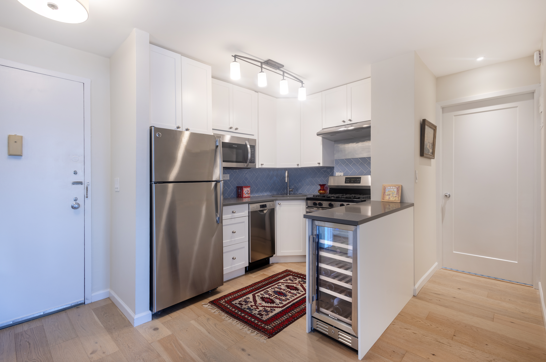 130 West 67th Street, Unit 26D Manhattan, NY 10023 - Photo 6 of 9 a kitchen with stainless steel appliances granite countertop a refrigerator and a stove