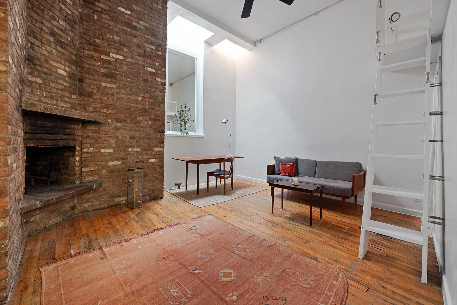 260 West 10th Street, Unit 1E Manhattan, NY 10014 - Photo 7 of 9 a reading room with furniture and a fireplace