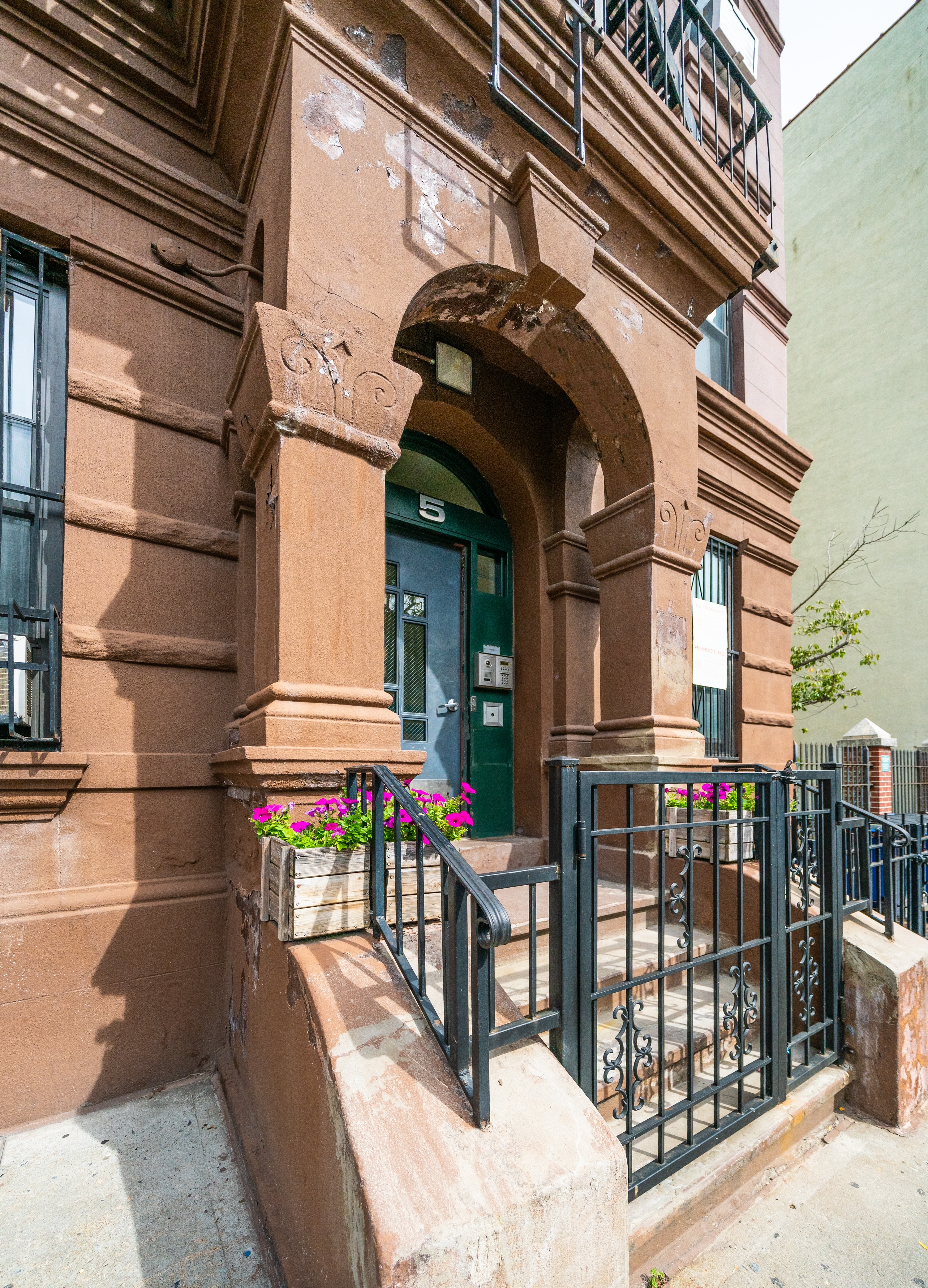 5 East 131st Street, Unit A3 Manhattan, NY 10037 - Photo 9 of 10 a front view of a house with large windows