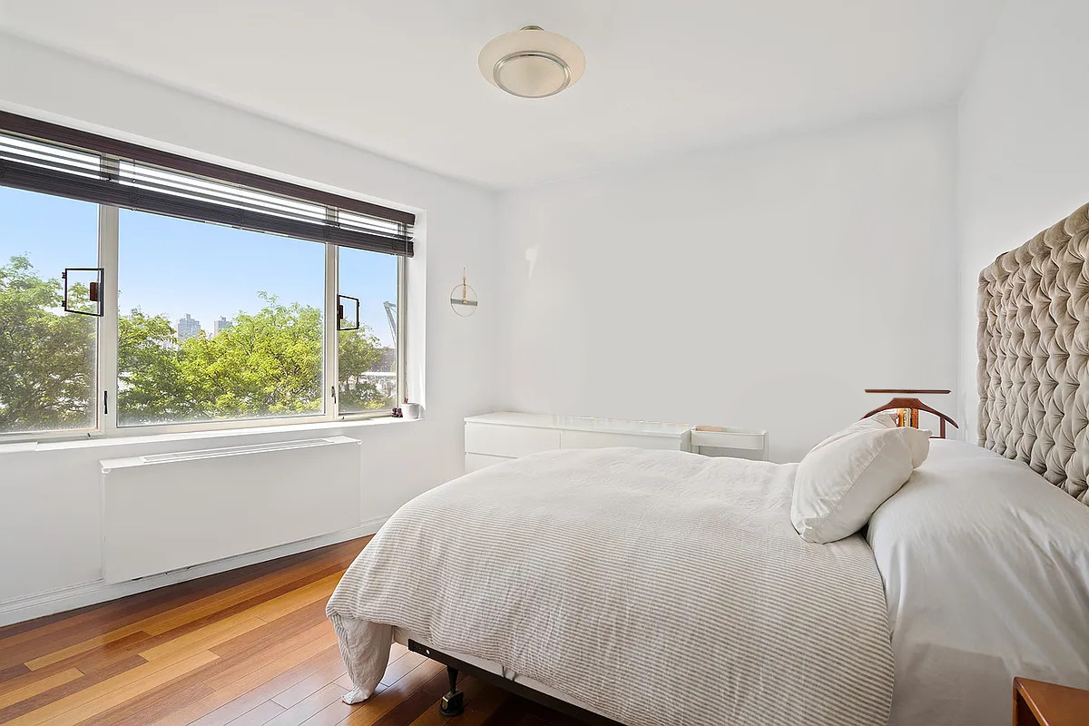 30-85 Vernon Boulevard, Unit 3M Queens, NY 11102 - Photo 4 of 8 a bedroom with a bed and a window