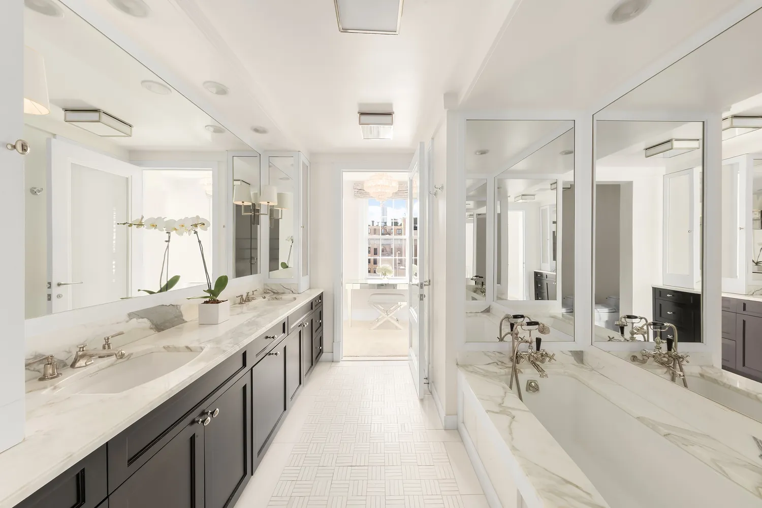 a bathroom with a double vanity sink double mirror and a bathtub