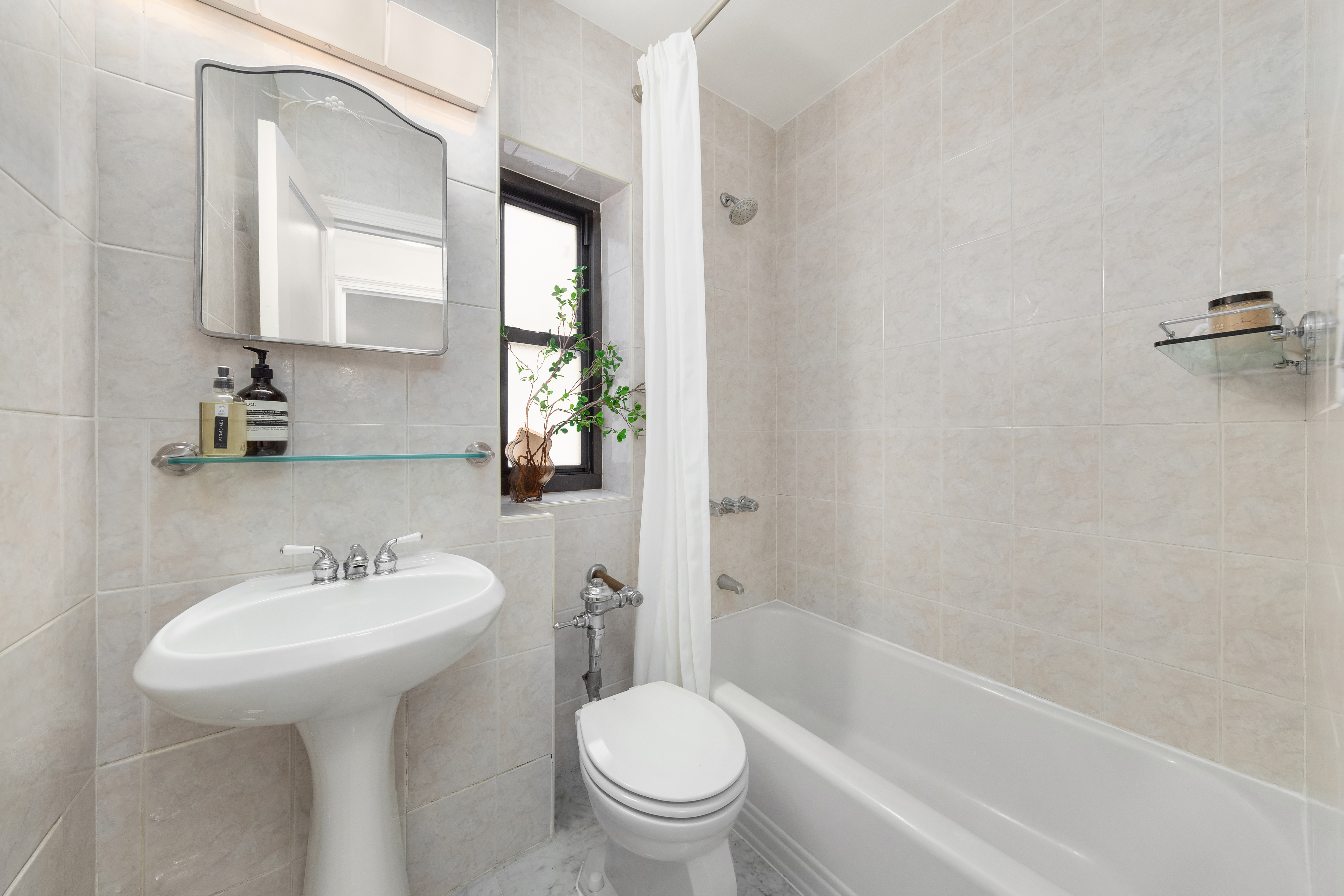 62 East 87th Street, Unit 5AB Manhattan, NY 10128 - Photo 7 of 10 a bathroom with a sink toilet and shower