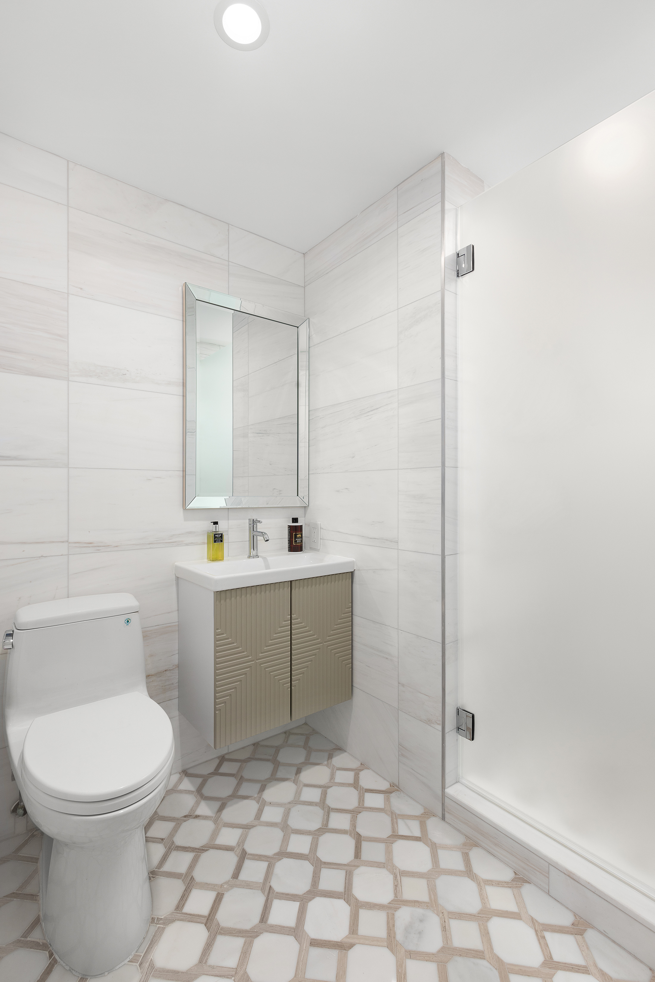 222 East 61st Street Manhattan, NY 10065 - Photo 25 of 30 a bathroom with a sink a toilet and shower