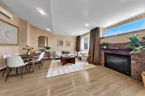 a living room with furniture a fireplace and a table