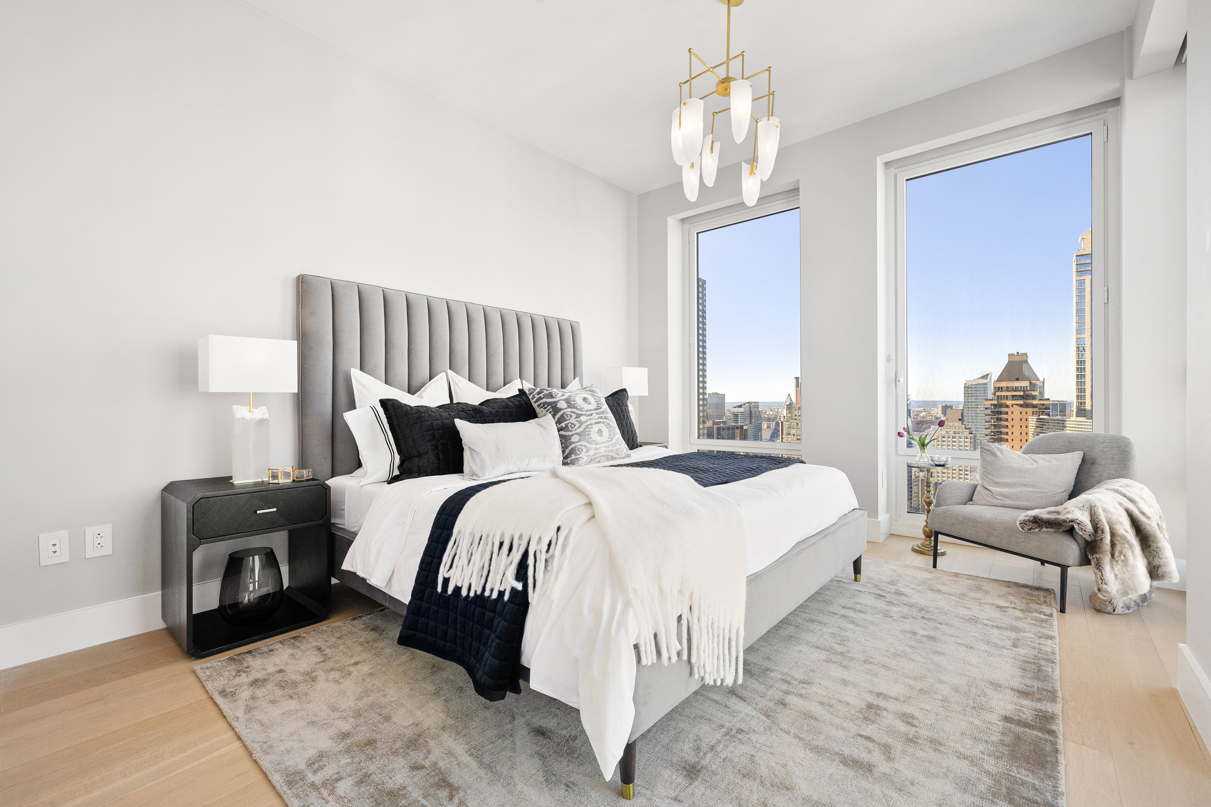 15 West 61st Street, Unit PH1C Manhattan, NY 10023 - Photo 14 of 26 a bed room with a bed and a chandelier