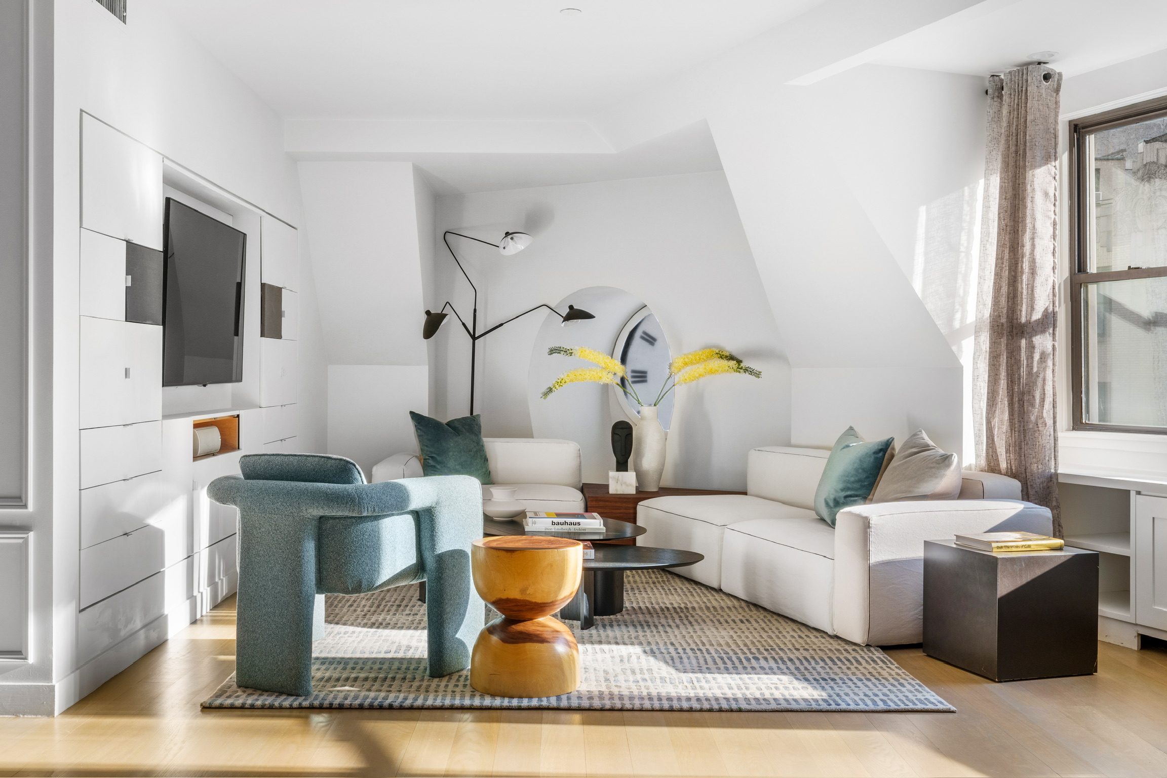 1200 Broadway, Unit PH89 Manhattan, NY 10001 - Photo 10 of 47 a living room with fireplace furniture and a flat screen tv