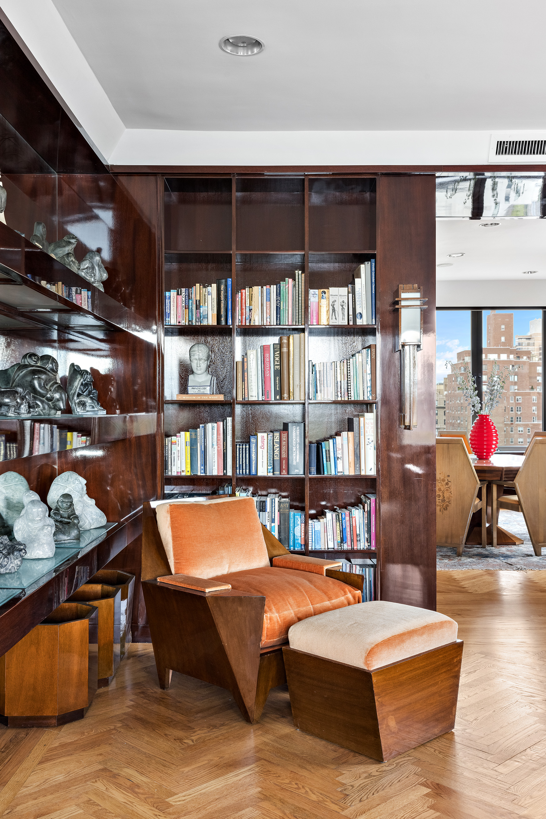 1115 5th Avenue, Unit 15A Manhattan, NY 10128 - Photo 10 of 27 a living room with furniture and a book shelf