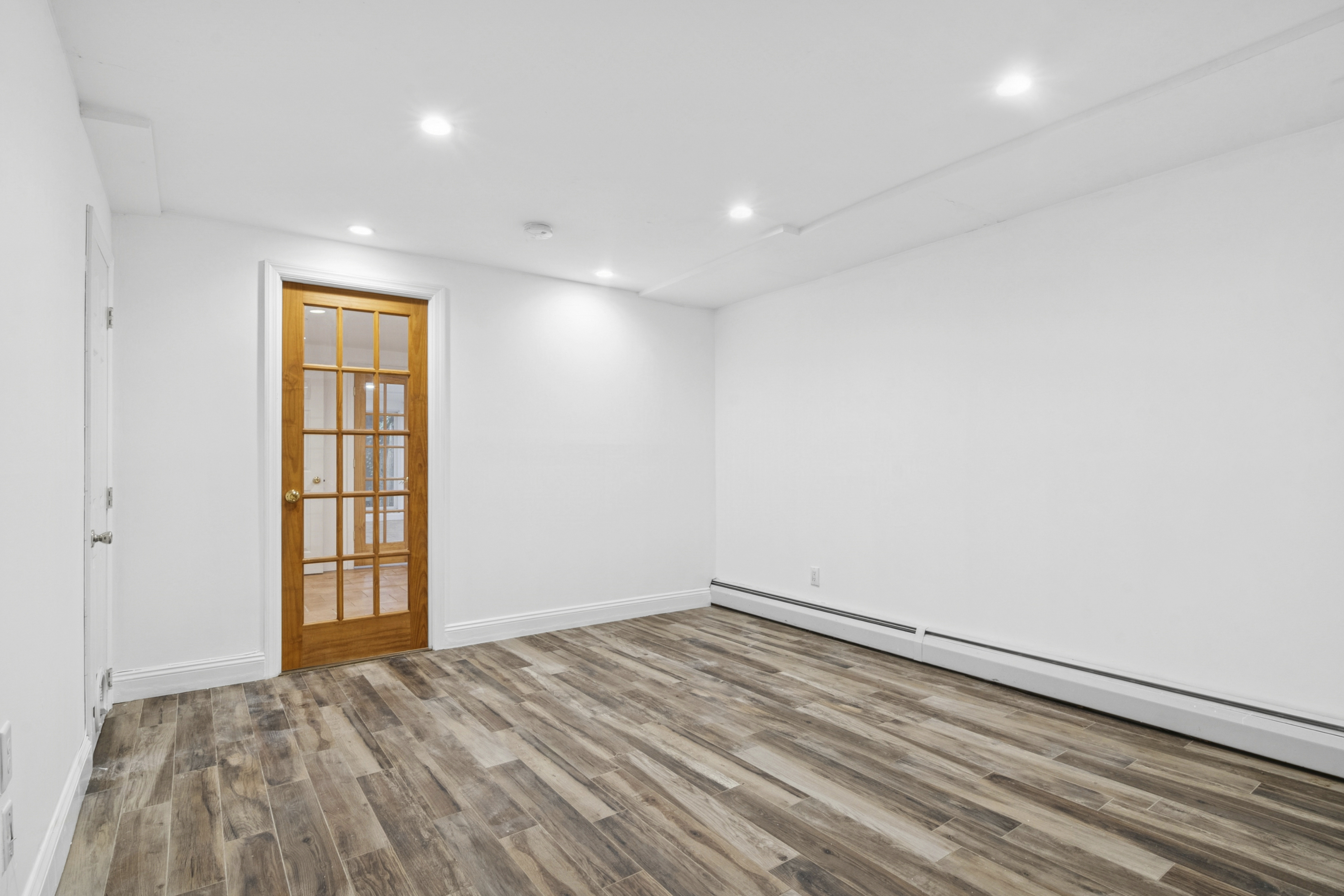 594 6th Avenue, Unit 1 Brooklyn, NY 11215 - Photo 10 of 13 a view of empty room with wooden floor and fan