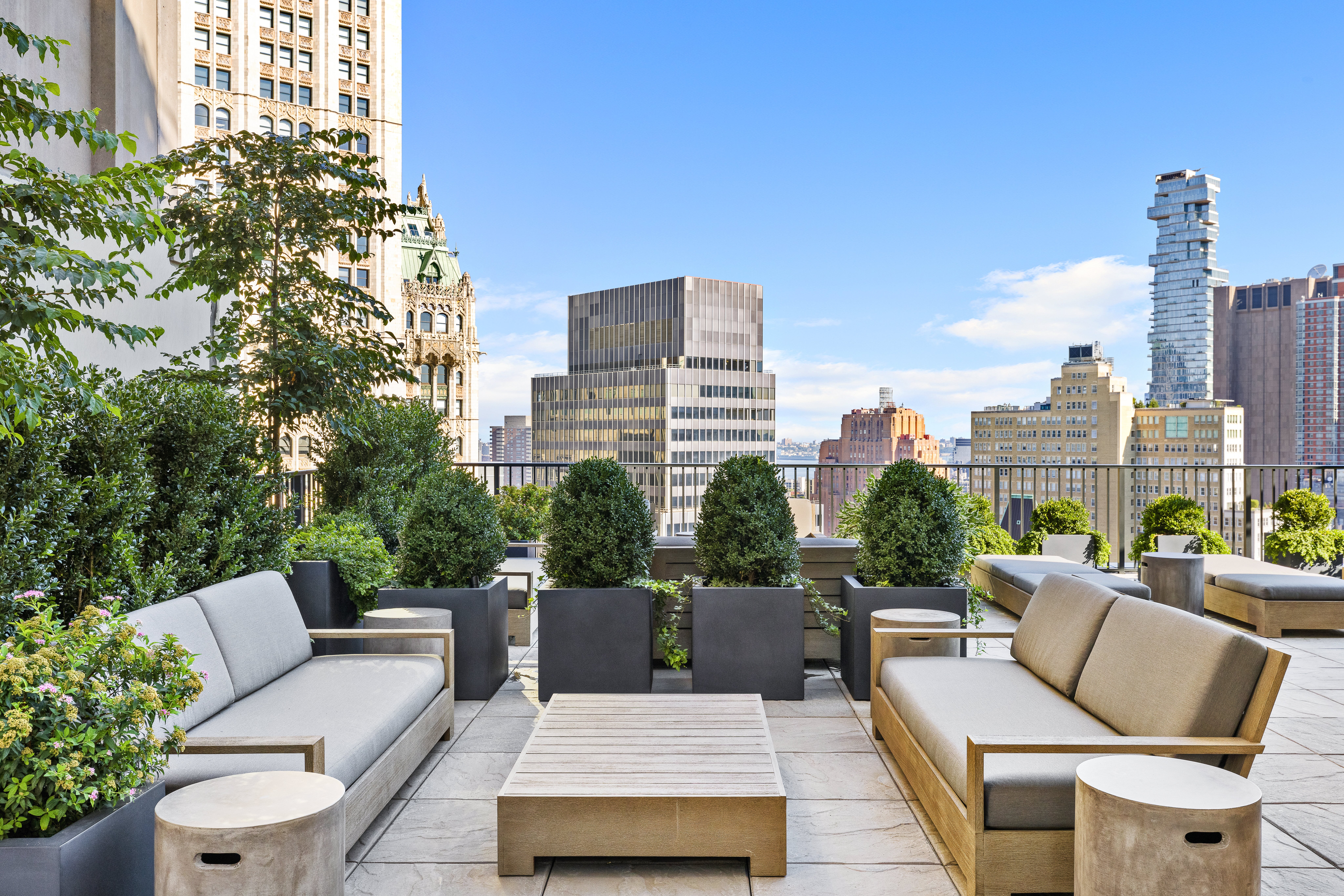33 Park Row, Unit 16A Manhattan, NY 10038 - Photo 17 of 24 a view of a roof deck with couches and potted plants