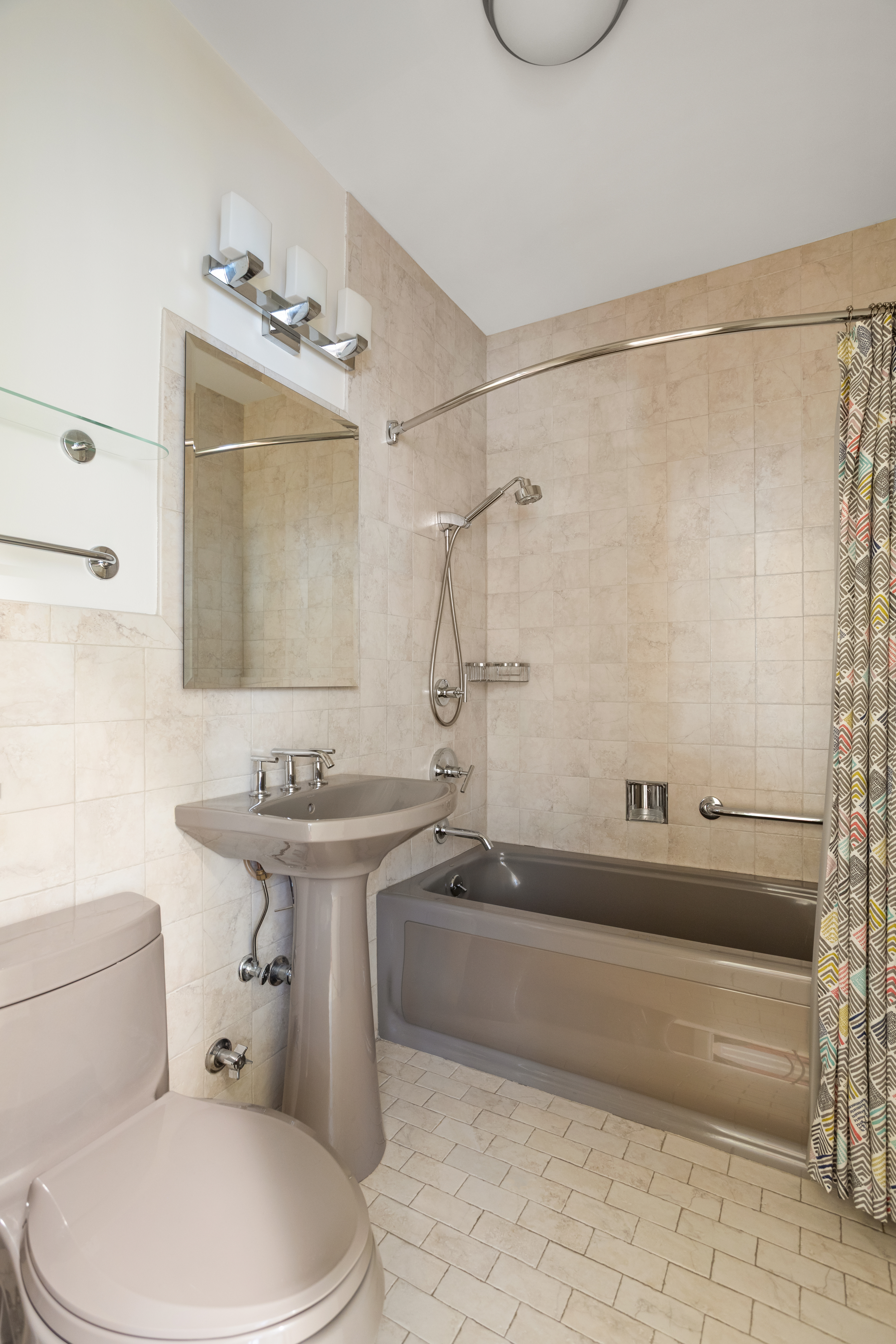 161 East 90th Street, Unit 3B Manhattan, NY 10128 - Photo 8 of 11 a bathroom with a sink toilet and shower