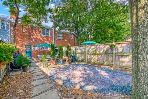 a view of a backyard with wooden fence