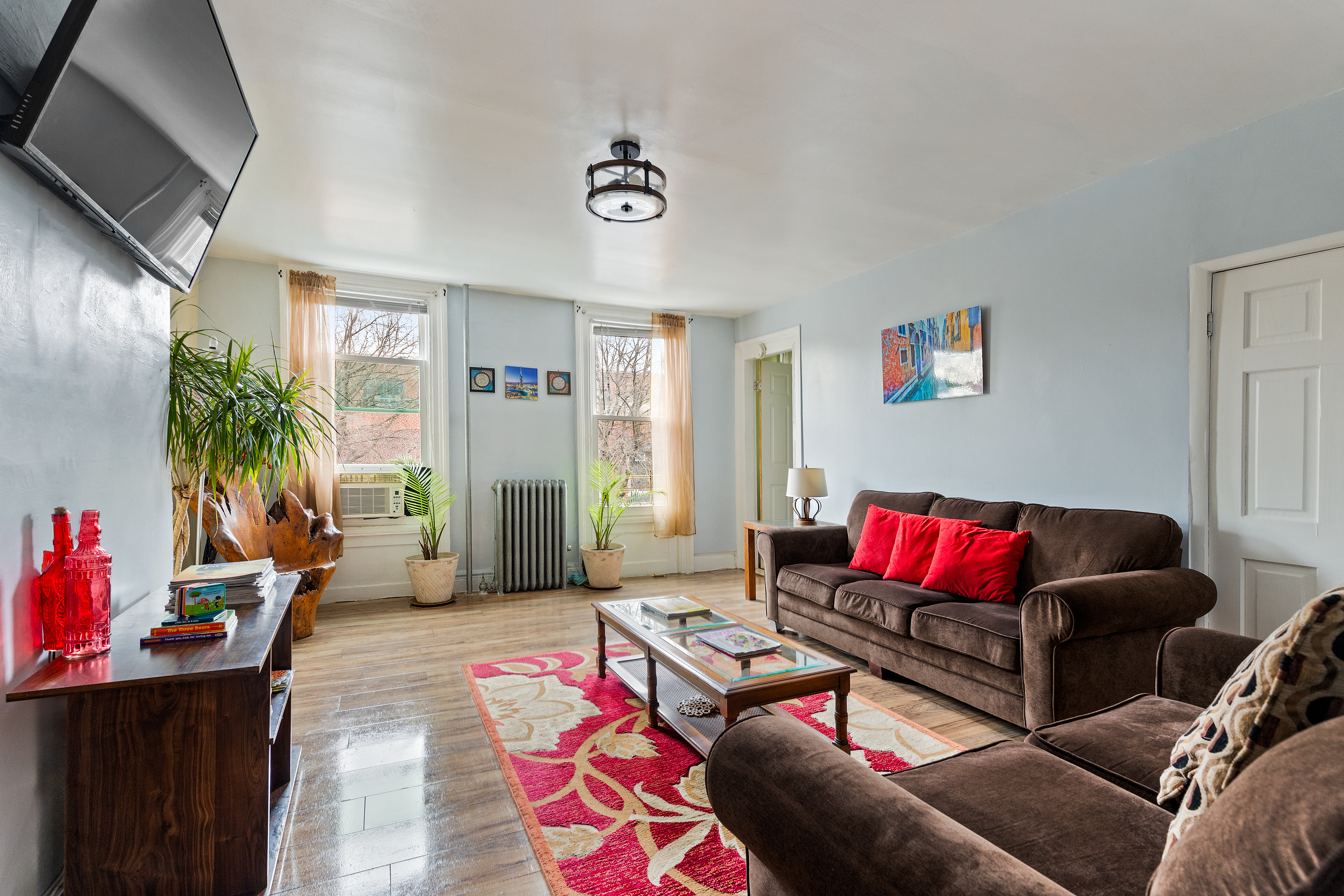 415 Monroe Street Brooklyn, NY 11221 - Photo 4 of 9 a living room with furniture and wooden floor