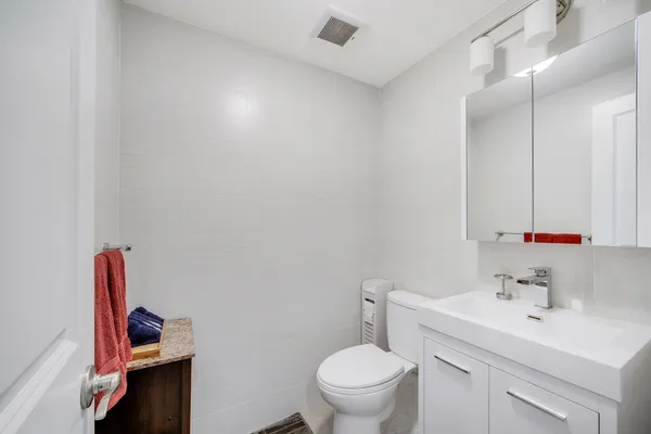 a bathroom with a sink toilet and vanity
