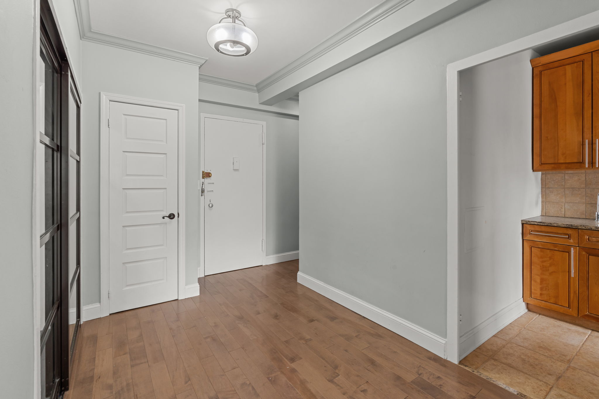 2 Tudor City Place, Unit 6JOS Manhattan, NY 10017 - Photo 7 of 16 a view of a hallway with wooden floor and cabinet
